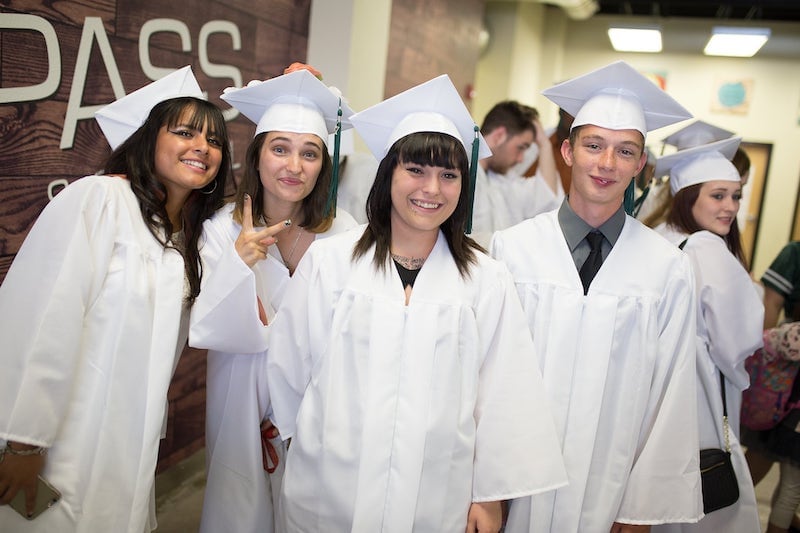 Group of four compass high school graduates